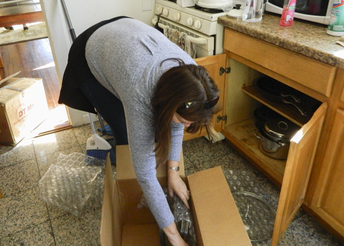 Woman unpacking a box.