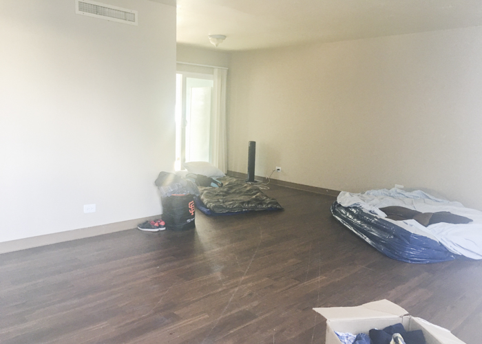 Empty living room with air mattress on the floor.